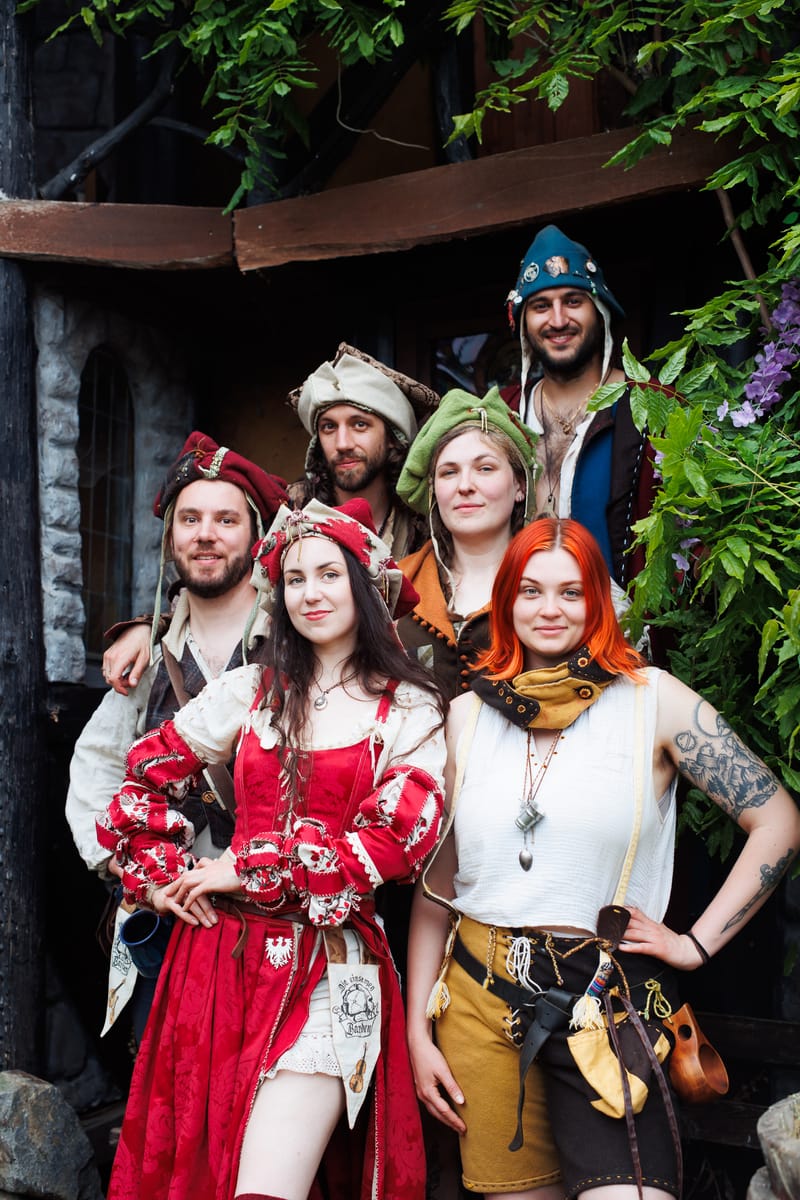 Our six musicians in medieval fantasy clothing, posing smiling.